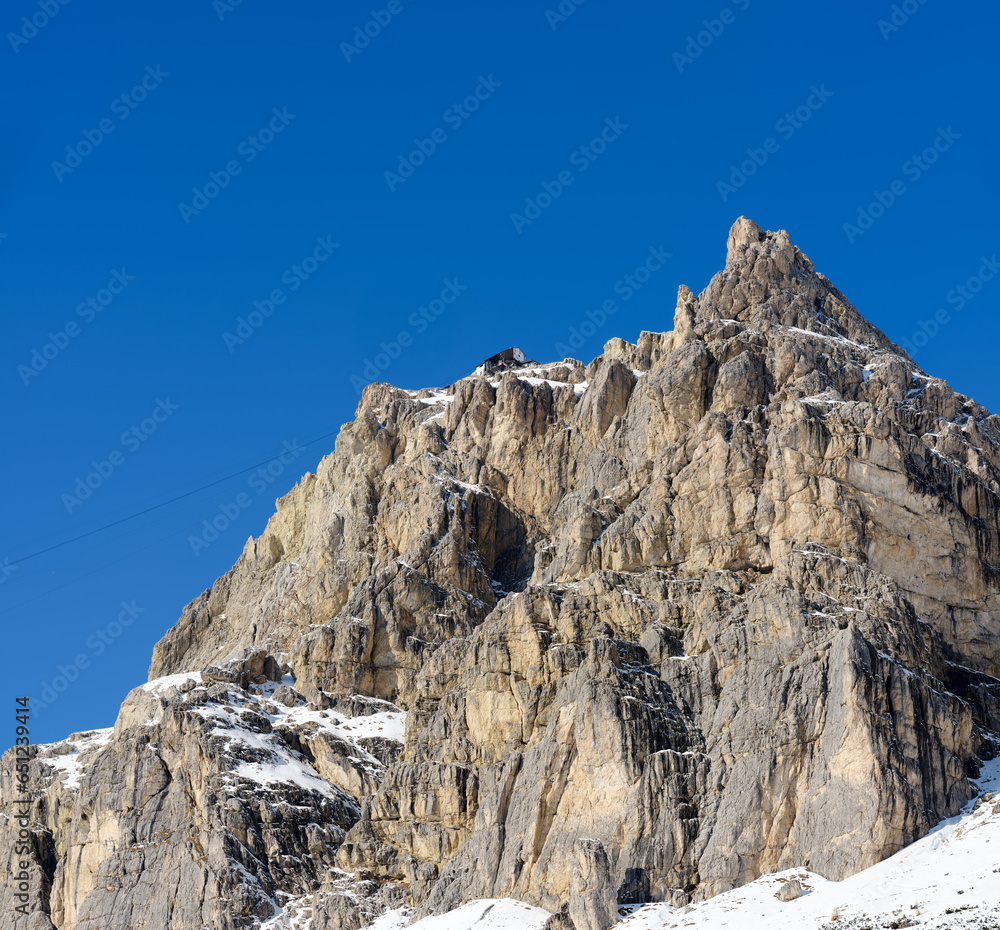 Autumn foliage in the woods of the Dolomites, near the ski slopes of Passo Falzarego in Cortina d'Ampezzo, Veneto, Italy, Europe. In the background the Sorapis Massif, a mountain range with characteri