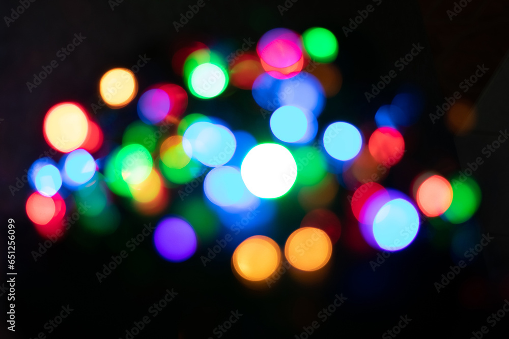 Festive Christmas and New Year background with bokeh, blurred lights on black background Festive Christmas and New Year background with bokeh, blurred lights on black background