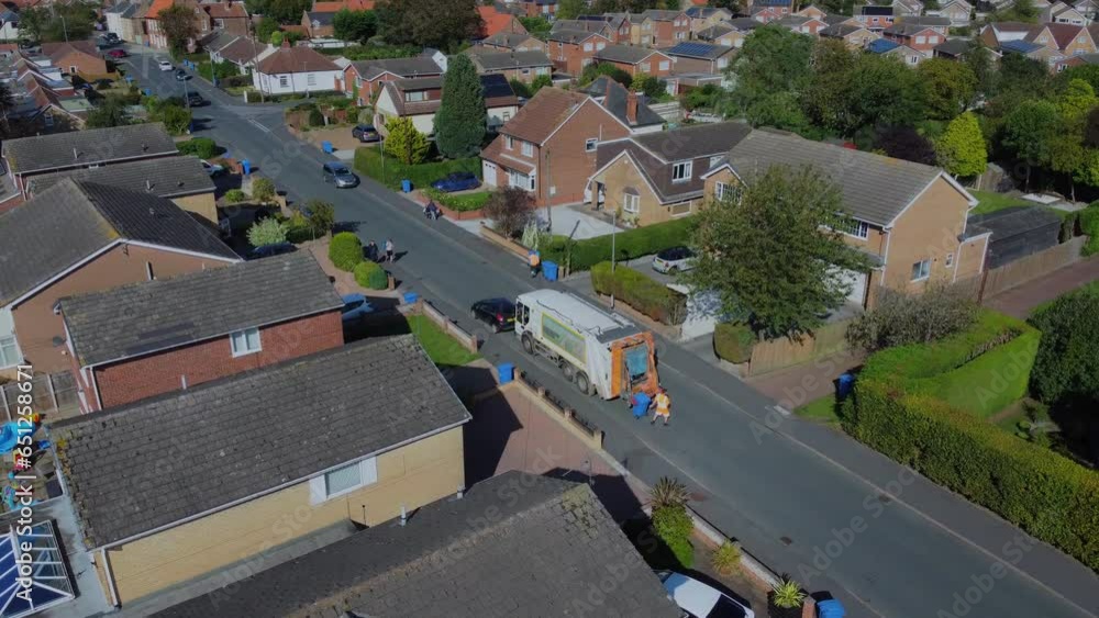 Drone. Waste collection truck in urban street collecting trash. UK Drone. Waste collection truck in urban street collecting trash. UK