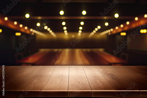 Blurred background of stage bar or cafe lounge with empty wooden table and bokeh light