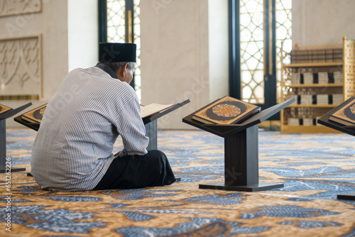 Muslim old man reading holy Quran. Islamic concept
