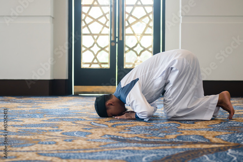 Muslim men praying in sujud or prostration posture