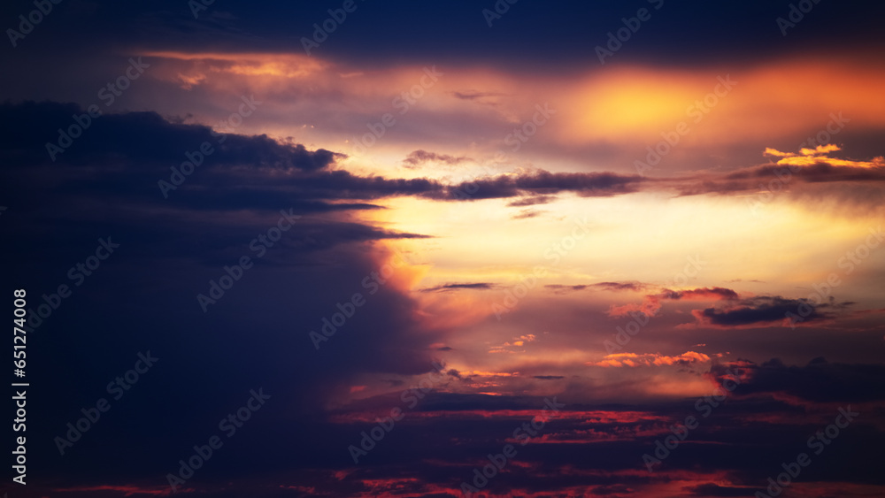 Picturesque view of orange sky with dark clouds in sunset time