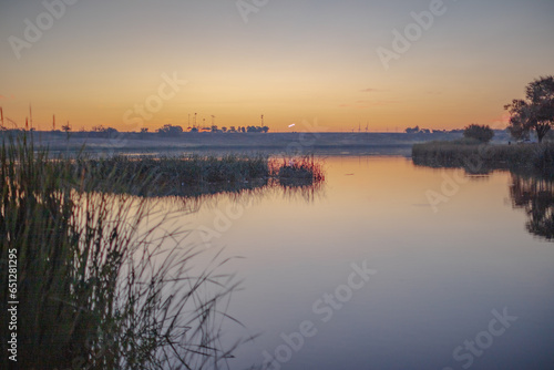 Landscape photo at Dunbar Historical Lake Lubbock Texas of sunrise over water