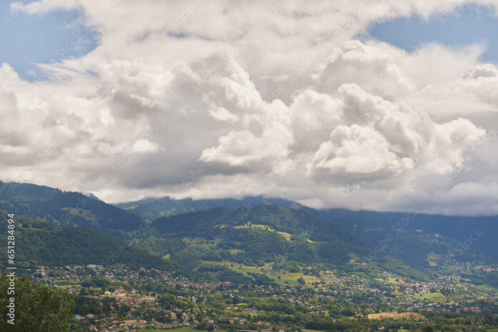 Beautiful summer mountain landscape with fluffy clouds, image taken in canton of Vaud, Switzerland