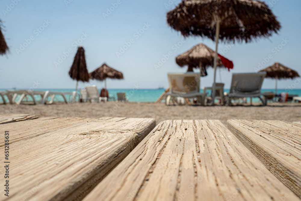 wooden plank path background with typical blurred umbrella and chairs atmosphere, beach holiday relax during sunny day in tropical resort, nobody wooden plank path background with typical blurred umbrella and chairs atmosphere, beach holiday relax during sunny day in tropical resort, nobody
