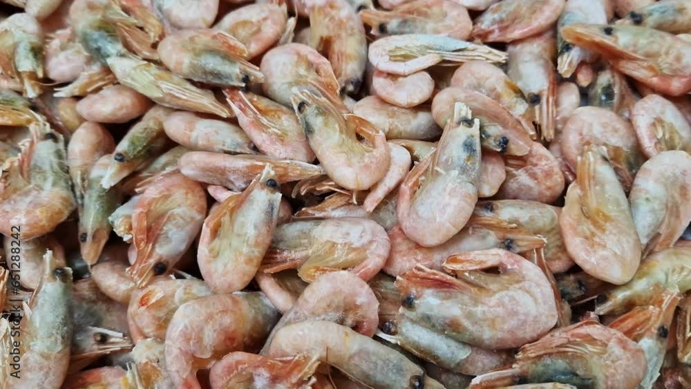Selling frozen shrimp in a supermarket. Shrimp at the fish market, smooth camera movement. Seafood. Raw shrimp close-up in a supermarket refrigerator Selling frozen shrimp in a supermarket. Shrimp at the fish market, smooth camera movement. Seafood. Raw shrimp close-up in a supermarket refrigerator