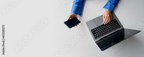 Type search information from the Internet network. Businessman working with smartphone, tablet and laptop computer on table in office. network concept