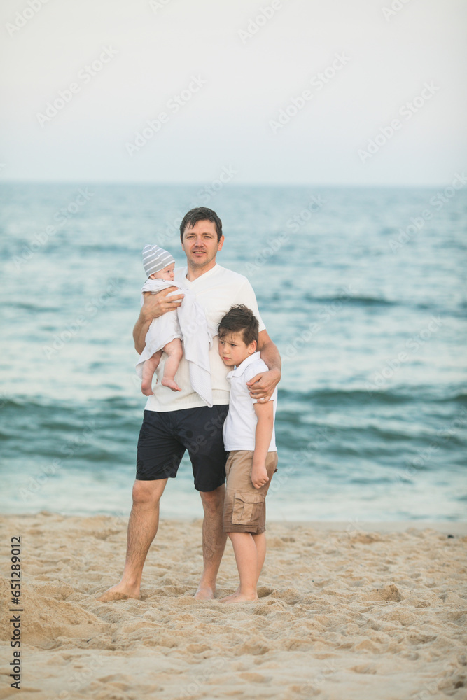 Father and child playing on tropical beach at sunset. Family summer vacation at sea resort. Dad playing with kids on sunny evening at ocean shore. Travel with children. Parent love Father and child playing on tropical beach at sunset. Family summer vacation at sea resort. Dad playing with kids on sunny evening at ocean shore. Travel with children. Parent love