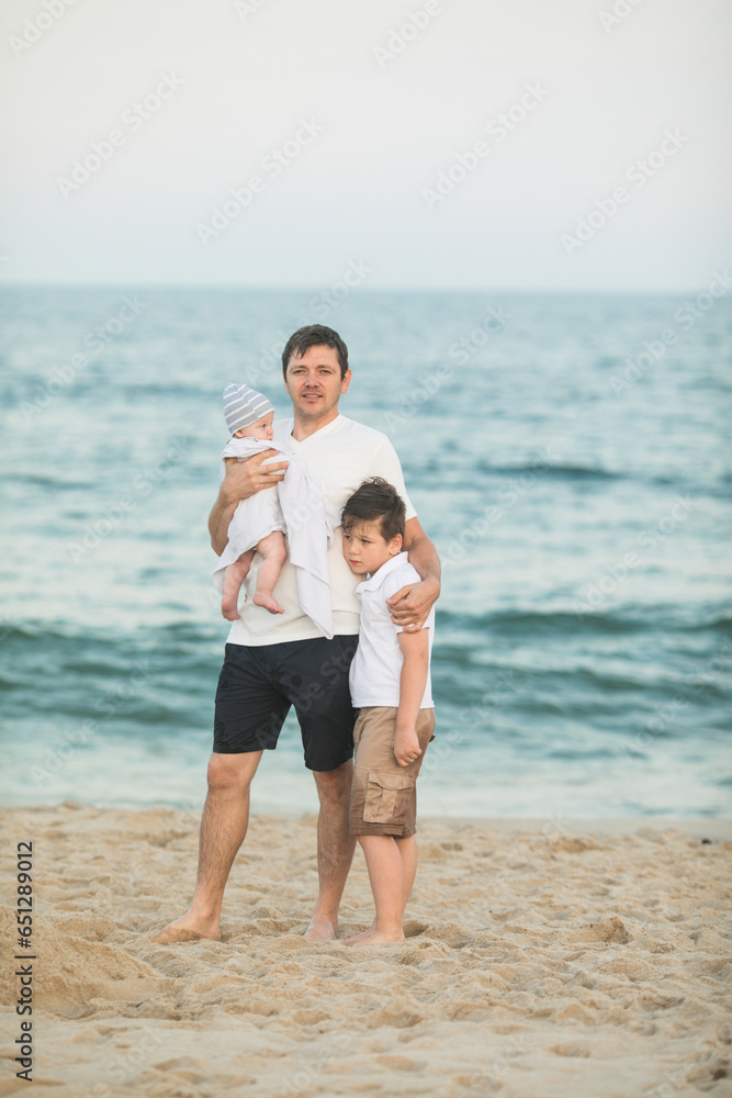 Father and child playing on tropical beach at sunset. Family summer vacation at sea resort. Dad playing with kids on sunny evening at ocean shore. Travel with children. Parent love