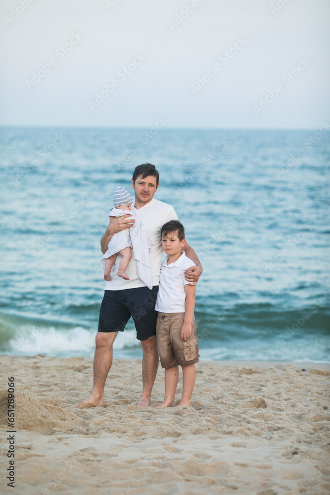 Father and child playing on tropical beach at sunset. Family summer vacation at sea resort. Dad playing with kids on sunny evening at ocean shore. Travel with children. Parent love