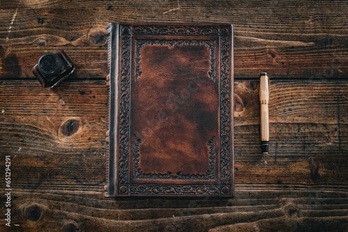 Brown leather cover of elegant journal captured on wooden table
