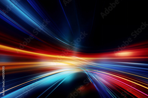 Abstract image of bright colored light streaks of red, orange and blue in motion on a black background