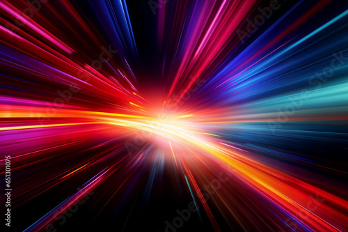 Abstract image of bright colored light streaks of red, orange and blue in motion on a black background