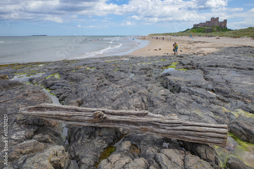 Bamburgh, UK - 14 July, 2023: Bamburgh castle and Northumbrian coast photo