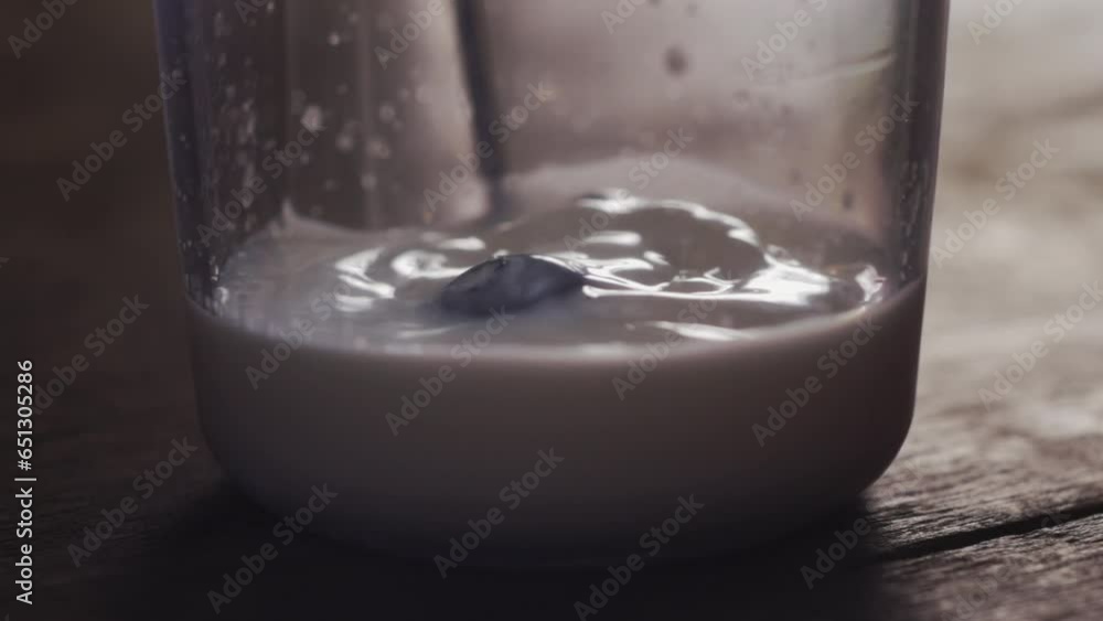 Slow Motion Blueberries Free Fall in Milk Slow Motion Blueberries Free Fall in Milk