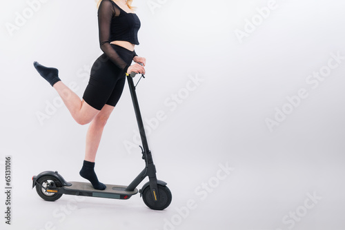 Full length profile shot of a female on an electric scooter isolated on white and red background
