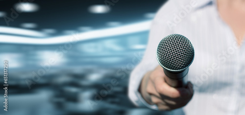 A journalist shows a microphone.