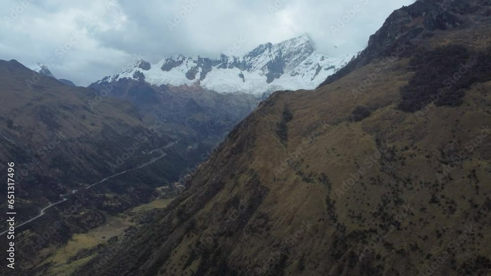 Camera moving sideways to reveal the face of Nevado Mateo mountain peaks with glaciers on a cloudy day Aerial Video. Camera moving sideways to reveal the face of Nevado Mateo mountain peaks with glaciers on a cloudy day Aerial Video.