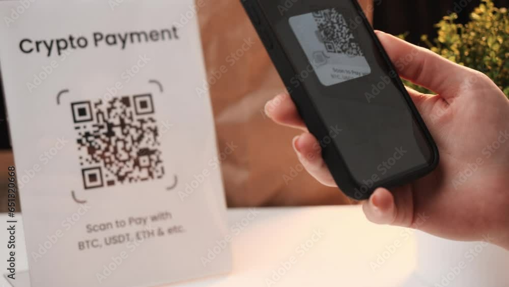 QR code crypto currency payment. Using a smartphone app, scan a QR code and pay with cryptocurrency for shopping.