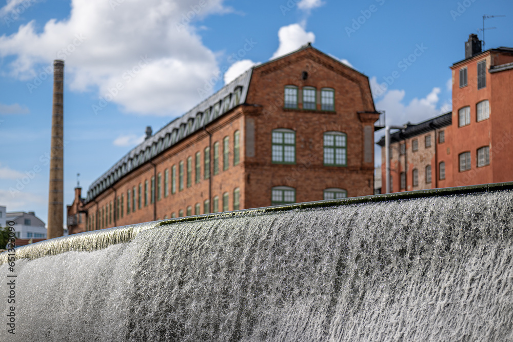 Motala river and the old industrial landscape during summer. Norrköping is a historic industrial town in Sweden. Motala river and the old industrial landscape during summer. Norrköping is a historic industrial town in Sweden.