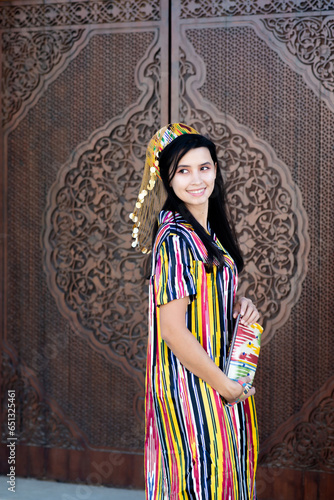 Beautiful girl in Uzbekistan, national fancy folk dress. Tashkent photo