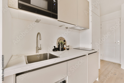 Modern kitchen with white counter and sink