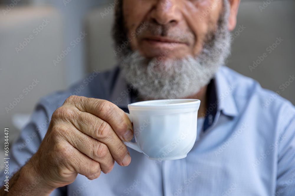 Old man drinking coffee with smile on his face Old man drinking coffee with smile on his face