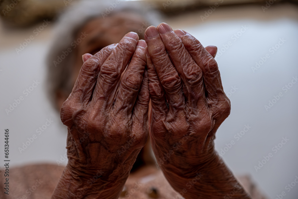 Old woman hands praying for god rising her hands Old woman hands praying for god rising her hands