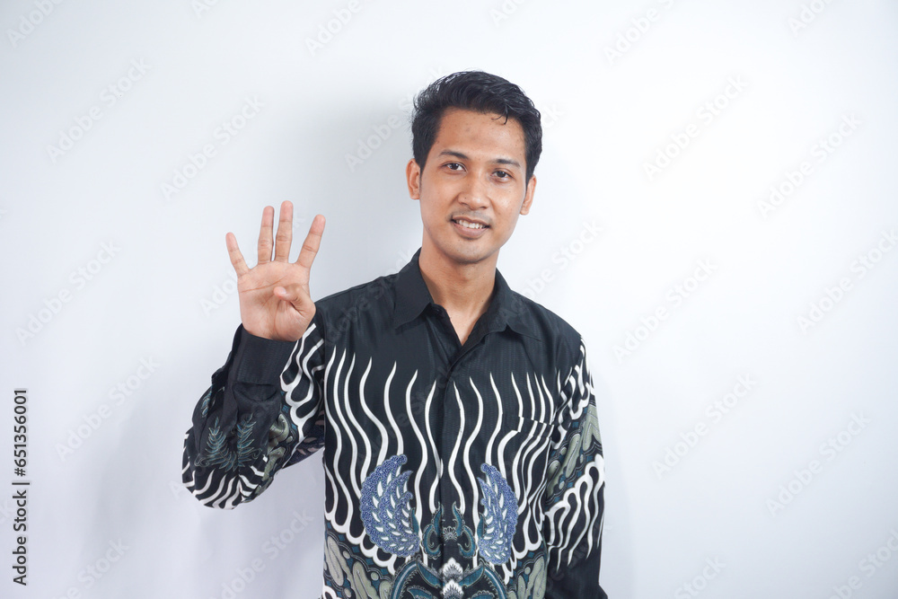 Fototapeta premium Young handsome man over isolated background showing and pointing up with finger number four while smiling confident and happy.