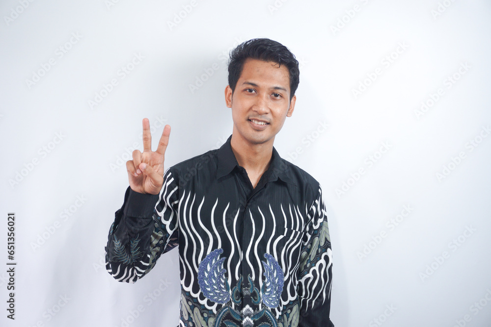 Young handsome man over isolated background showing and pointing up with finger number two while smiling confident and happy. Young handsome man over isolated background showing and pointing up with finger number two while smiling confident and happy.