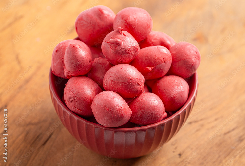 Red Freeze Dried Saltwater Taffy Isolated on a Rustic Wood Table Red Freeze Dried Saltwater Taffy Isolated on a Rustic Wood Table