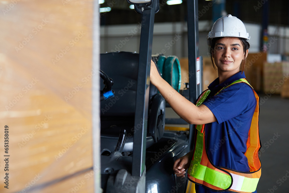 Indian worker get in a forklift in the warehouse storage Indian worker get in a forklift in the warehouse storage