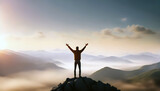 Motivational image of a lonely man at the top of a mountain raising his hands in the air at sunrise.