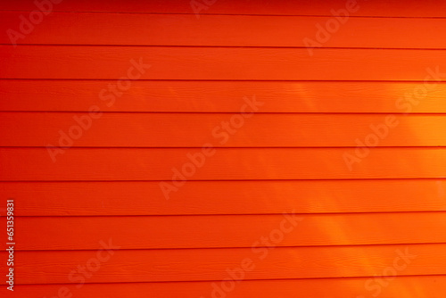 Texture of a red wooden wall. Beautiful wooden boards of red color.