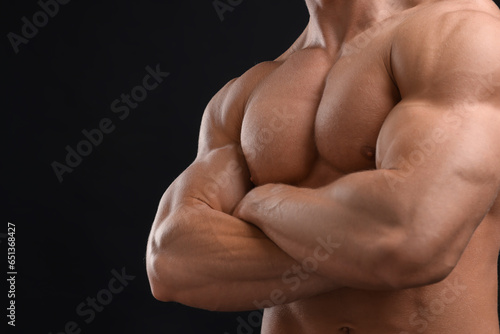 Muscular man on black background, closeup and space for text. Sexy body