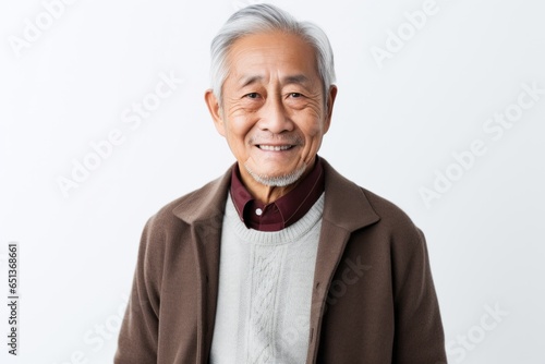 Medium shot portrait photography of a Vietnamese man in his 80s against a white background