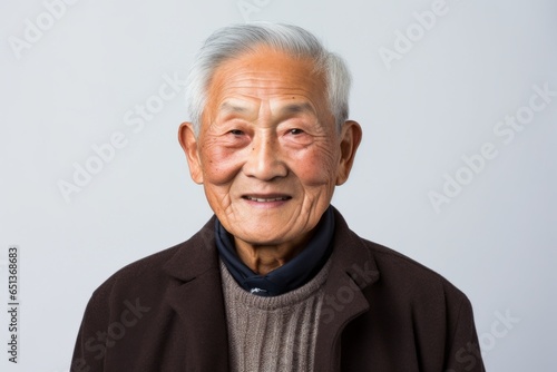 Close-up portrait photography of a 100-year-old elderly Vietnamese man against a white background © Robert MEYNER