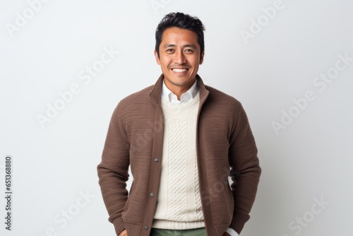 Lifestyle portrait photography of a tender Peruvian man in his 30s against a white background