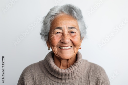 Group portrait photography of a Peruvian woman in her 90s wearing a cozy sweater against a white background