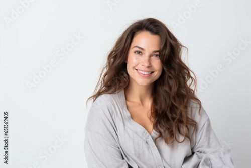 Medium shot portrait photography of a French woman in her 30s wearing a snuggly pajama set against a white background © Robert MEYNER