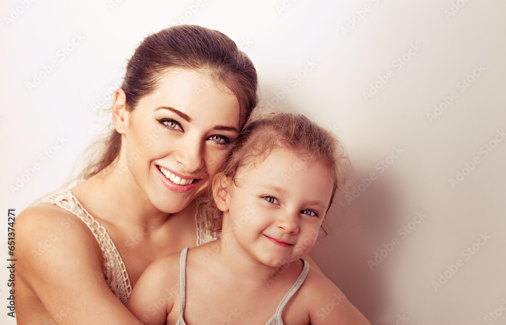 Enjoying beautiful young mother cuddling with love her cute baby girl. Closeup toned vintage Enjoying beautiful young mother cuddling with love her cute baby girl. Closeup toned vintage