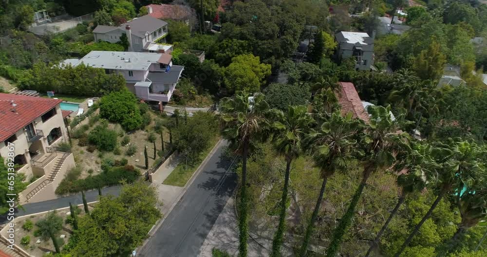 Aerial Panning Shot Of Bungalows Near Road Amidst Trees In Suburb On Sunny Day - Los Angeles, California Aerial Panning Shot Of Bungalows Near Road Amidst Trees In Suburb On Sunny Day - Los Angeles, California