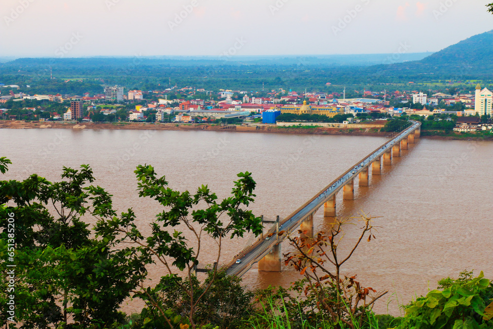 Lao-Nippon Bridge, a Japanese-funded concrete suspension bridge over Mekong River at southern Lao town of Pakse in Champasak Province, Lao. View from Phu Salao Lao-Nippon Bridge, a Japanese-funded concrete suspension bridge over Mekong River at southern Lao town of Pakse in Champasak Province, Lao. View from Phu Salao