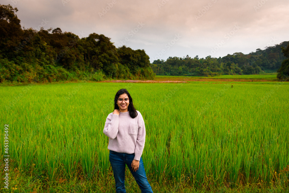 Enjoying the nature. Beautiful and young Indian woman enjoying the fresh air in green paddy farm. Enjoying the nature. Beautiful and young Indian woman enjoying the fresh air in green paddy farm.