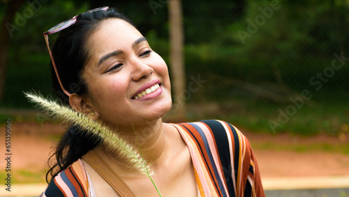 Portrait of a Young Indian pretty smiling girl in park
