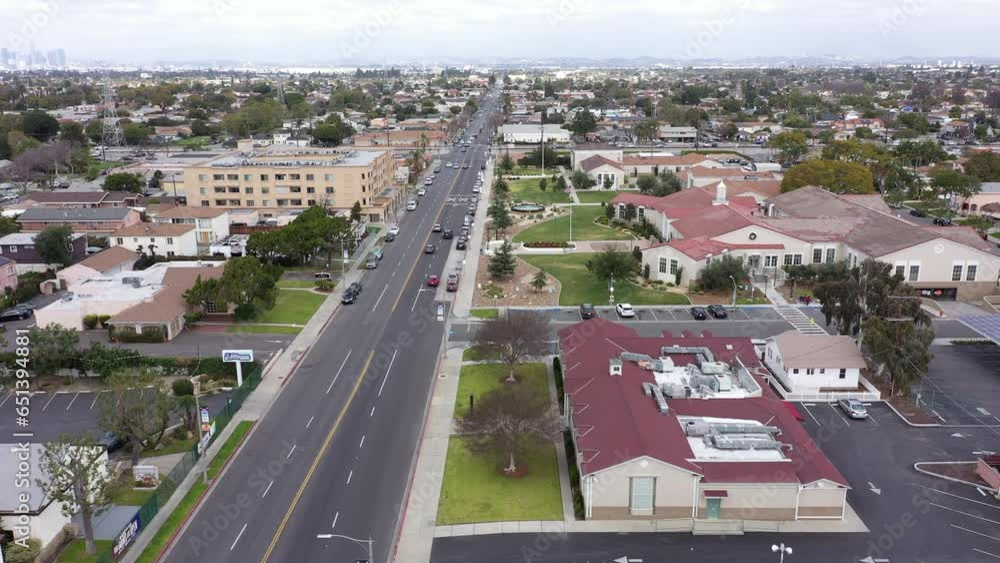 South Gate, California, USA - February 11, 2023: Traffic passes through the urban core of South Gate. South Gate, California, USA - February 11, 2023: Traffic passes through the urban core of South Gate.