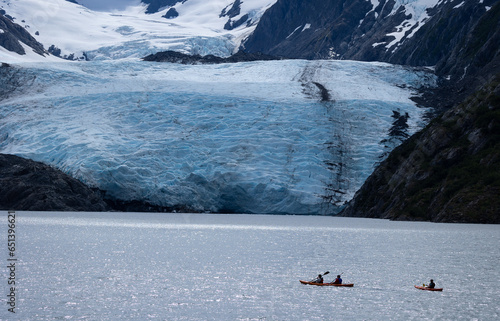 Kayakers near portage glacier valley in Alaska. Exciting adventure and tourism.  photo