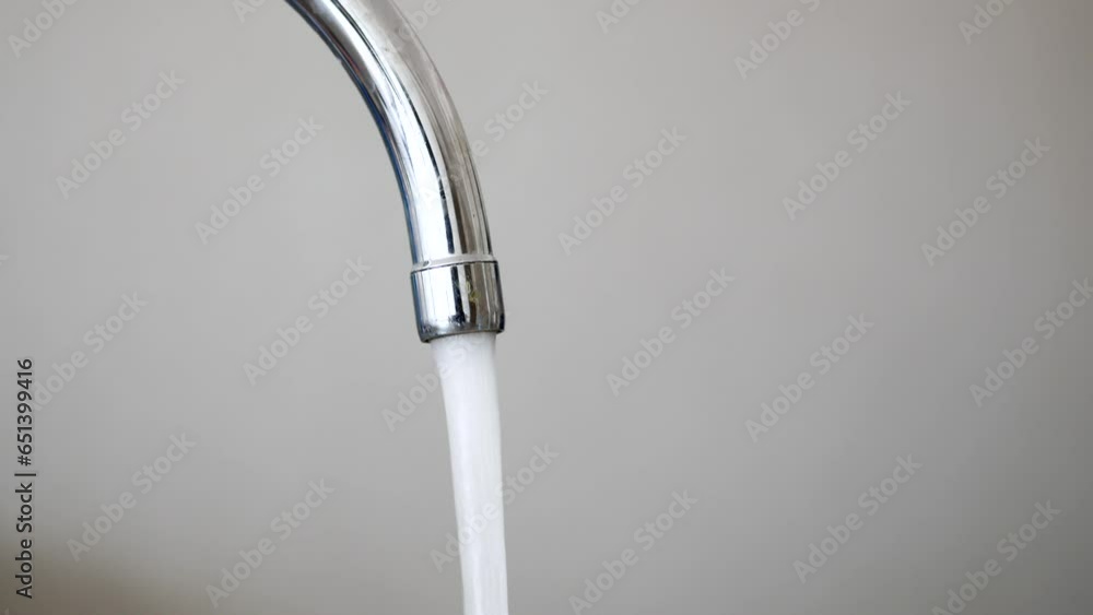 water pouring from a faucet tap slow motion water pouring from a faucet tap slow motion