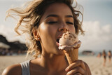 Close-up of a woman's mouth sticking out her tongue licking chocolate ice cream on the beach